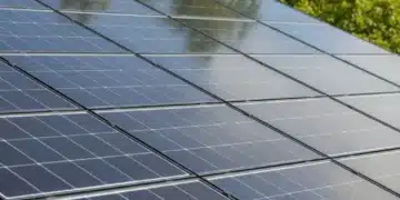 Clean residential solar panels on a rooftop under a clear blue sky, illustrating optimal performance.